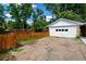 Detached garage with fresh white paint, a convenient double door, and a spacious driveway at 2240 S Clermont St, Denver, CO 80222