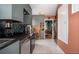 View of the kitchen with stainless steel appliances and an open doorway to the dining room at 2240 S Clermont St, Denver, CO 80222