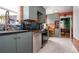 Updated kitchen featuring stainless steel appliances, mosaic backsplash and gray cabinets at 2240 S Clermont St, Denver, CO 80222