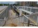 Light rail station featuring tracks, covered platforms, and pedestrian access via stairs at 2240 S Clermont St, Denver, CO 80222
