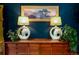 Side table arrangement with two lamps and artwork displayed against a blue wall at 2240 S Clermont St, Denver, CO 80222