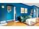 Inviting living room with hardwood floors, a comfortable green sofa, and blue walls at 2240 S Clermont St, Denver, CO 80222