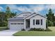 Charming one-story home with gray siding, manicured lawn, and attached two-car garage at 1352 Lumber Ridge N Cir, Erie, CO 80516