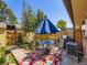 Serene backyard patio with dining set, lush landscaping, and a privacy fence, perfect for outdoor entertaining at 5525 S Lowell Blvd, Littleton, CO 80123
