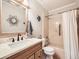 Renovated bathroom featuring tub shower, updated fixtures, and seashell decor at 5525 S Lowell Blvd, Littleton, CO 80123
