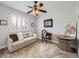 Bright bedroom with a ceiling fan, window with shutters, and a desk area for a functional space at 5525 S Lowell Blvd, Littleton, CO 80123