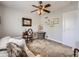 Inviting bedroom featuring neutral decor, a ceiling fan, and ample space for relaxation and comfort at 5525 S Lowell Blvd, Littleton, CO 80123
