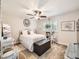 Comfortable bedroom with a ceiling fan, plants, and white wicker furniture at 5525 S Lowell Blvd, Littleton, CO 80123
