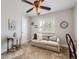 Cozy bedroom featuring a sofa, soft carpet, ceiling fan, and window shutters for a peaceful ambiance at 5525 S Lowell Blvd, Littleton, CO 80123