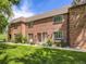 Charming brick facade with well-manicured lawn, inviting entrance, and cozy curb appeal on a sunny day at 5525 S Lowell Blvd, Littleton, CO 80123