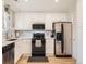Modern kitchen with stainless steel appliances, white cabinets, and ample counter space, perfect for cooking and entertaining at 5525 S Lowell Blvd, Littleton, CO 80123
