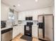 Updated kitchen features white cabinets, stainless steel appliances, and modern countertops at 5525 S Lowell Blvd, Littleton, CO 80123