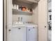 Convenient laundry closet with a washer, dryer, and shelving for efficient storage at 5525 S Lowell Blvd, Littleton, CO 80123