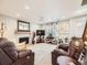 Inviting living room with a fireplace, plush seating, and natural light, perfect for relaxation and entertaining guests at 5525 S Lowell Blvd, Littleton, CO 80123