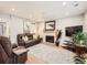 Living room features a fireplace, hardwood floors, a comfortable seating area, and a modern TV setup at 5525 S Lowell Blvd, Littleton, CO 80123