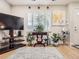 Bright living room with natural light, shuttered windows, modern artwork, and stylish decor at 5525 S Lowell Blvd, Littleton, CO 80123