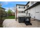 Backyard view of the modern home with a tiled patio and a dark gray hot tub at 3366 Willow St, Denver, CO 80238