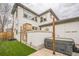 View of stucco home's outdoor space with stone fireplace detail and a covered hot tub at 3366 Willow St, Denver, CO 80238