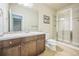 Standard bathroom with a tile shower, tile floor, and a wooden vanity at 3366 Willow St, Denver, CO 80238