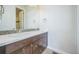 Modern bathroom with double sinks, granite counters, mosaic backsplash, and tile flooring at 3366 Willow St, Denver, CO 80238