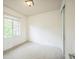 This bedroom has neutral carpet and paint, window with blinds, closet, and white trim at 3366 Willow St, Denver, CO 80238