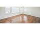 This bonus room has dark wood floors, multiple windows with blinds, and white trim at 3366 Willow St, Denver, CO 80238