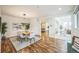 Bright dining room featuring hardwood floors, a modern light fixture, and an open concept design at 3366 Willow St, Denver, CO 80238