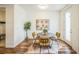 Dining nook with a round table, three chairs and access to the backyard through a glass door at 3366 Willow St, Denver, CO 80238