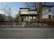 Charming two-story home featuring stone accents, large windows, and a well-maintained front yard with a black iron fence at 3366 Willow St, Denver, CO 80238