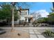 Landscaped front yard showcasing a modern home with stone accents, tidy garden beds and a black metal fence at 3366 Willow St, Denver, CO 80238