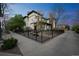 Attractive corner lot featuring a well-manicured lawn, landscaped garden beds, mature trees, and black metal fencing at 3366 Willow St, Denver, CO 80238