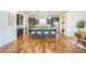 Open-concept kitchen featuring a large island with seating, stainless steel appliances, and dark cabinetry at 3366 Willow St, Denver, CO 80238
