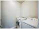 Functional laundry room with washer, dryer, and neutral tile flooring at 3366 Willow St, Denver, CO 80238