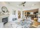 Bright living room features a fireplace, large windows, and open access to the kitchen, enhancing the living space at 3366 Willow St, Denver, CO 80238