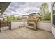 Outdoor patio featuring stone fireplace, privacy walls, and concrete flooring at 3366 Willow St, Denver, CO 80238