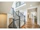 Elegant staircase with black railings, plush carpet, and abundant natural light. Open floor plan is visible in the background at 3366 Willow St, Denver, CO 80238