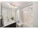 Clean full bathroom with tile surround, shower and tub, and updated vanity at 6774 S Independence St, Littleton, CO 80128