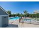 Community pool with lounge chairs, tables, and mature trees offers a relaxing outdoor space at 6774 S Independence St, Littleton, CO 80128