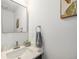 Stylish half bath featuring modern sink, marble countertop and brushed nickel finishes at 6774 S Independence St, Littleton, CO 80128