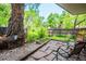 Backyard patio with stone walkway, mature trees, and lush landscaping with wooded fencing at 827 Maxwell Ave # H, Boulder, CO 80304
