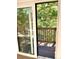 View from a sliding glass door onto a wooden deck surrounded by trees at 827 Maxwell Ave # H, Boulder, CO 80304