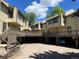 Exterior townhome view showcasing balconies and covered parking spots under a partly cloudy sky at 827 Maxwell Ave # H, Boulder, CO 80304