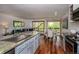 Open concept living room with large windows, hardwood floors, and granite countertops at 827 Maxwell Ave # H, Boulder, CO 80304