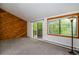 Spacious living room featuring a wooden accent wall and access to a patio at 827 Maxwell Ave # H, Boulder, CO 80304