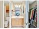 Bathroom with vanity, toilet, mirror and walk-in closet at 1099 S Walden Way # 205, Aurora, CO 80017