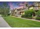 Charming townhouse complex showcasing landscaped front lawns and inviting entrances under a colorful twilight sky at 1099 S Walden Way # 205, Aurora, CO 80017