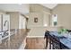 Kitchen area with granite countertops, stainless steel faucet, and view of the adjacent dining area at 1099 S Walden Way # 205, Aurora, CO 80017