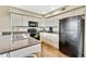 Functional kitchen features granite countertops, stainless sink, and all the necessary appliances for convenient cooking at 1099 S Walden Way # 205, Aurora, CO 80017