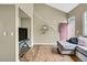 Open-concept living space with a high ceiling, hardwood flooring, and a stylish gray sectional at 1099 S Walden Way # 205, Aurora, CO 80017