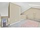 Cozy loft with neutral walls, carpet, and decor, with natural light filtering through the skylights at 1099 S Walden Way # 205, Aurora, CO 80017